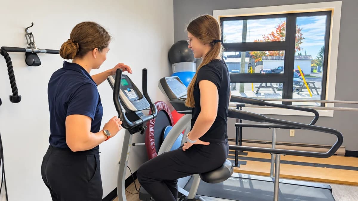 One-on-one guidance during exercise on a stationary bike.
